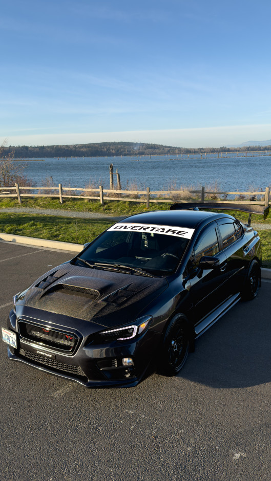 Sebastian S's 2017 WRX Upgraded Head Unit and Sound system with a carbon fiber steering wheel and carbon E-Brake